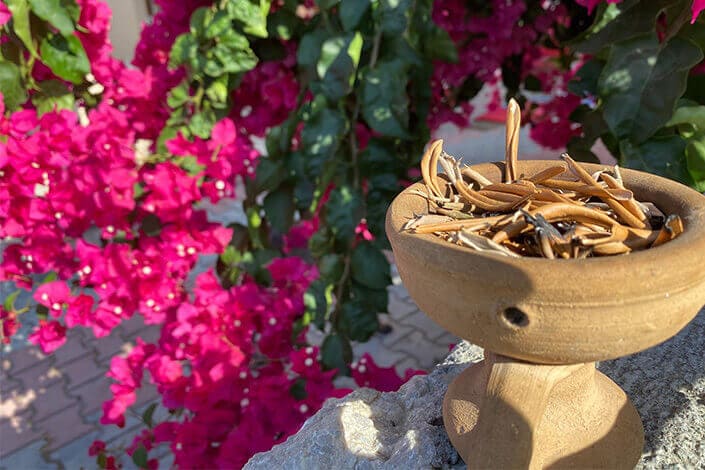 Burning olive leaves (also known as Tutsu) in a ceramic pot